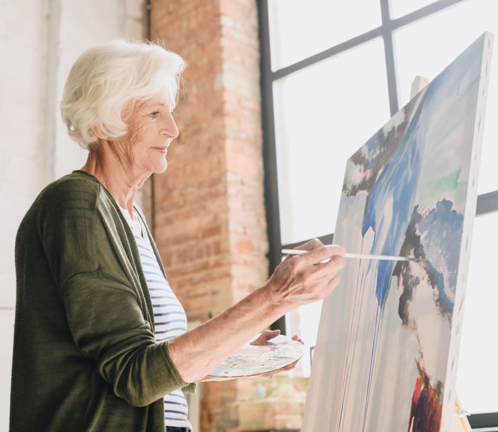 Woman resident painting at Clearwater at North Tustin in Santa Ana, California