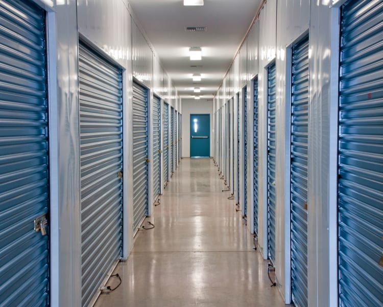 Interior storage units with blue doors at Storage Landing in Buda, Texas