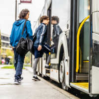 Students boarding bus near The Lofts At Clifford Brown Walk in Wilmington, Delaware