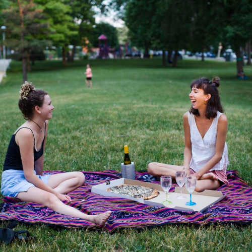 Two women enjoying picnic in the local park near The Gramercy Residences in Las Vegas, Nevada