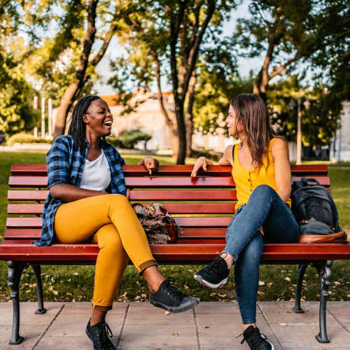 Residents having a chat on a park bench at MeadowView Townhomes in Goshen, Ohio