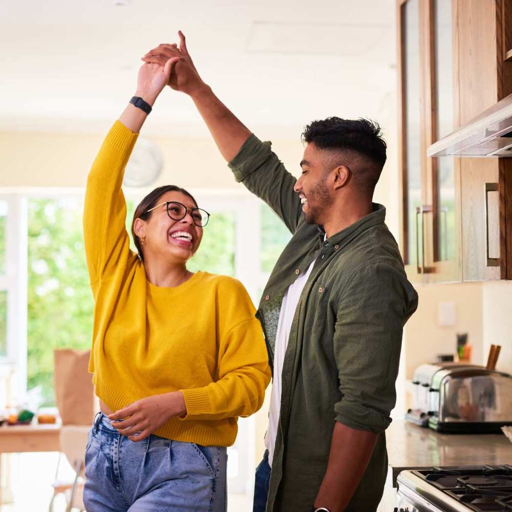 Resident couple having a good time in their apartment at Amaranth in Candler, North Carolina
