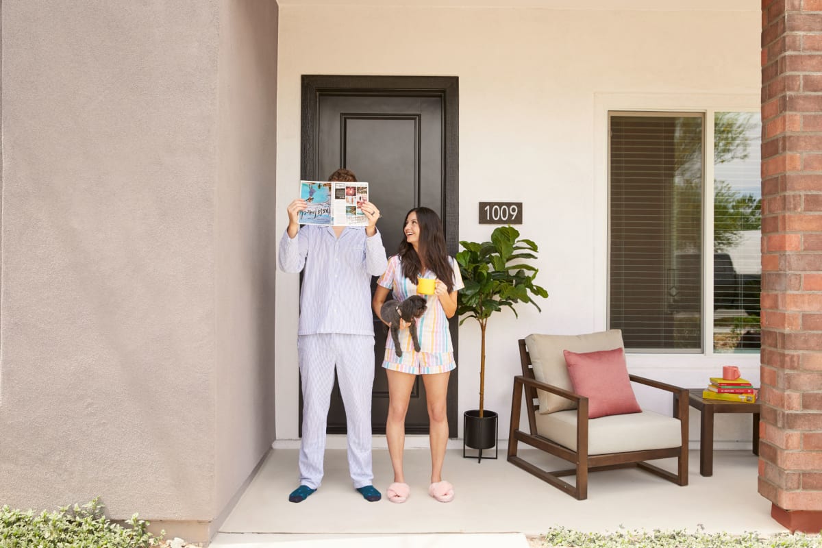 Two residents and their dog on their front porch at BB Living at Union Park in Phoenix, Arizona