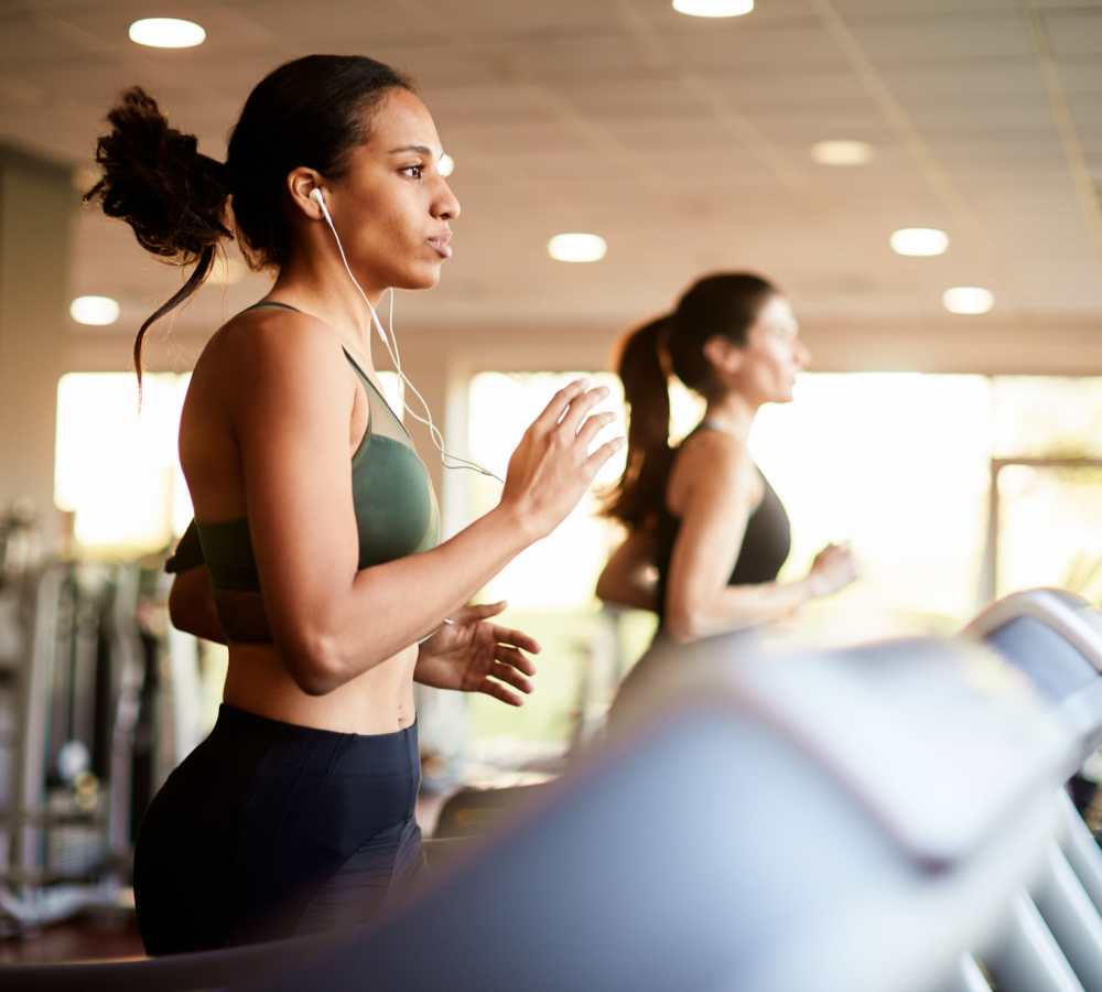 Resident exercising on a treadmill at Titan Court in Eugene, Oregon