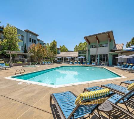 Pool tables and comfortable poolside seating at Azure Apartment Homes in Petaluma, California