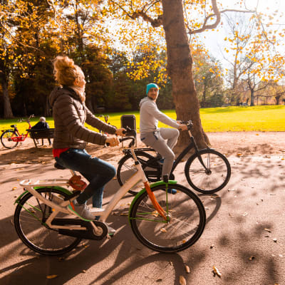 Resident couple riding bikes in park near Terra Apartment Homes in Federal Way, Washington