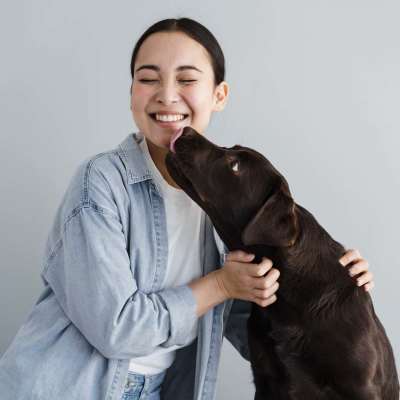 Resident playing with her dog at The Guild in Richmond, Virginia
