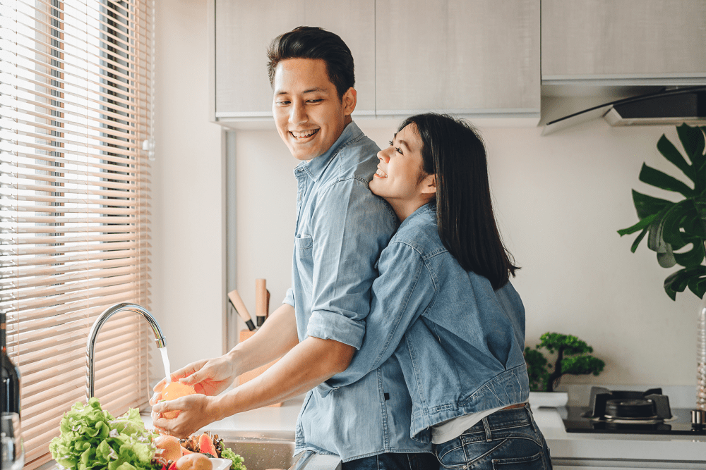 Couple cooking together in their full-equipped modern kitchen at Vantage Pointe West Apartment Homes in Cincinnati, Ohio