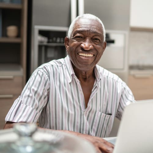 Resident at a computer at Truewood by Merrill, Bradenton in Bradenton, Florida. 