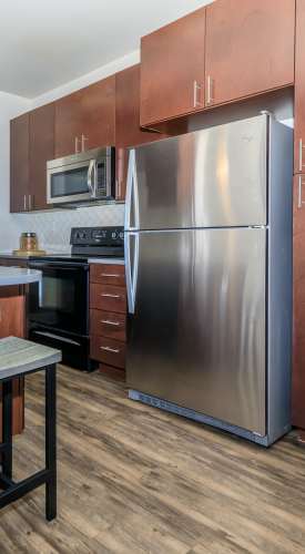 Apartment kitchen with wood-style flooring at Park Place Olde Town Apartments in Arvada,Colorado