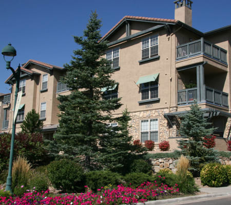 Building exterior with private balconies and beautifully landscaped grounds at Montrachet Apartment Homes in Lakewood, Colorado