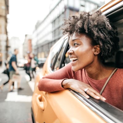 Resident taking a taxi and loving her decision to move to Tower 801 in Seattle, Washington