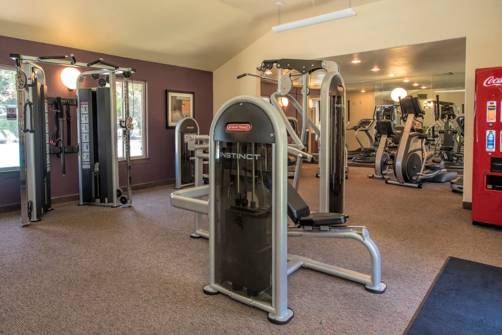 Fitness center with individual workout stations at La Valencia Apartment Homes in Campbell, California