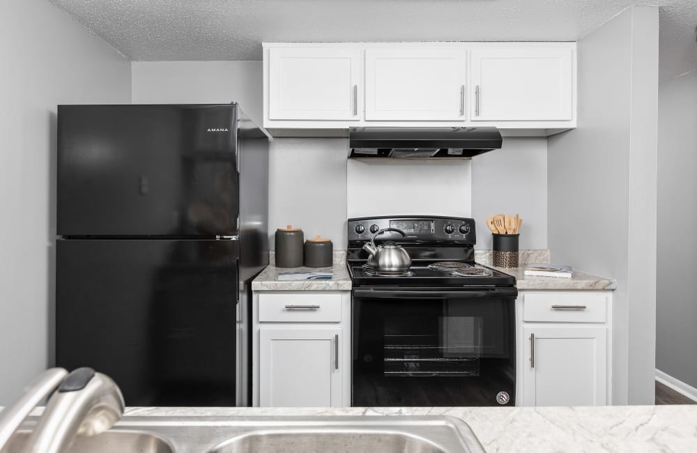 Kitchen with black appliances at Astoria Park Apartment Homes in Indianapolis, Indiana