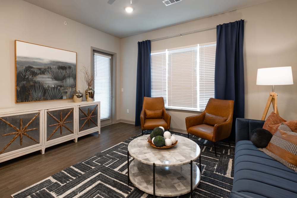 A fully furnished living room at The Reserve at Watermere Woodland Lakes in Conroe, Texas