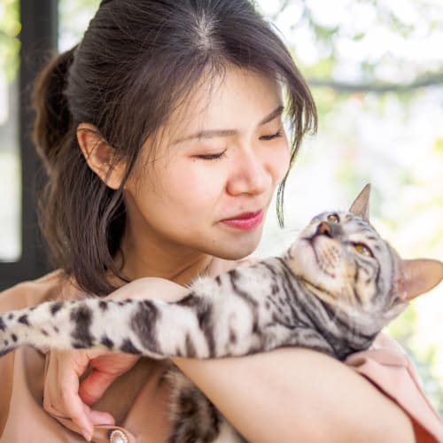 A resident holding a cat at Silver Strand II in Coronado, California