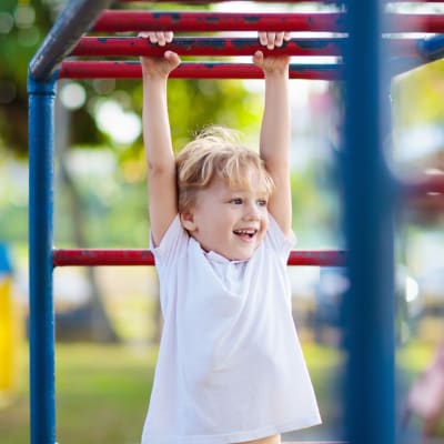 A child playing on a playground at Chollas Heights in San Diego, California