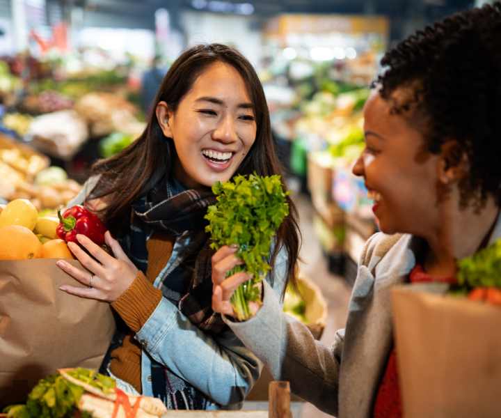 Two resident women shopping vegetables near Pelican Isles Apartments in Sebastian, Florida