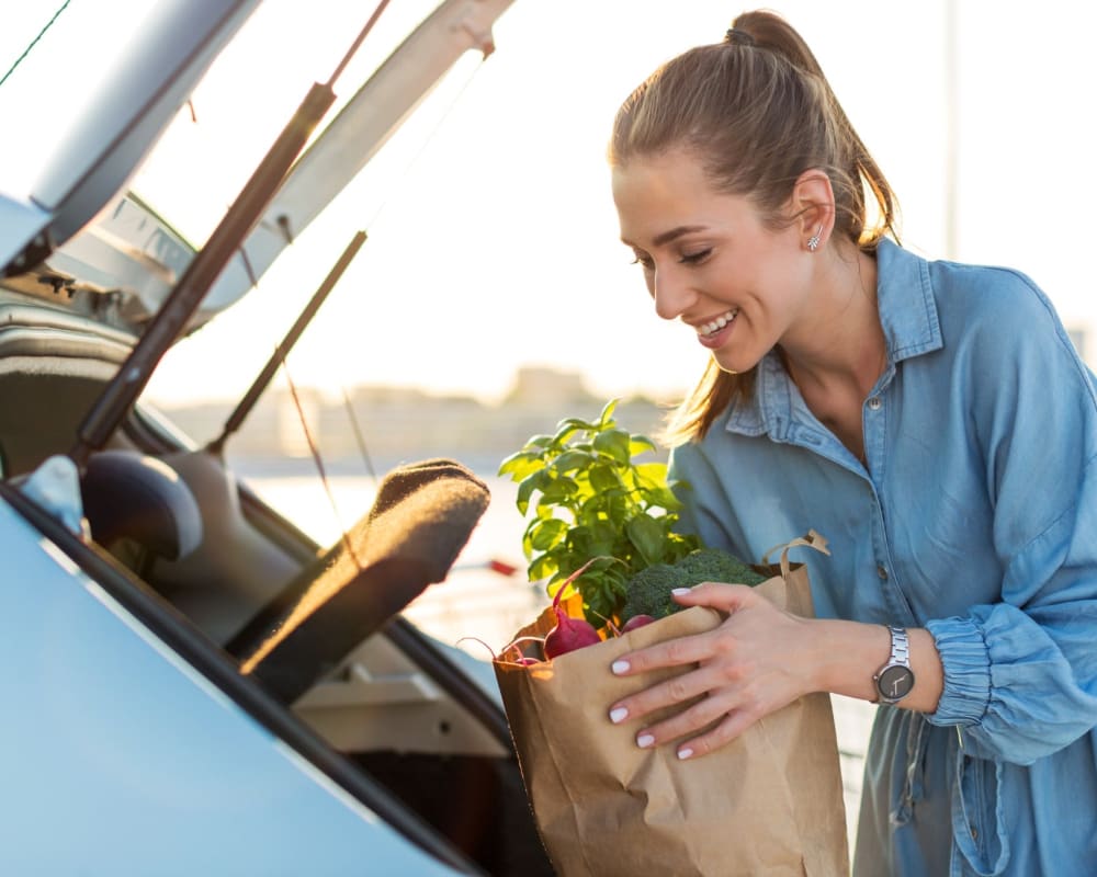 A resident loading groceries into her trunk at Adobe Flats V in Twentynine Palms, California