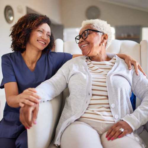 Resident and memory care team member smiling at The Residences at Thomas Circle in Washington, District of Columbia 