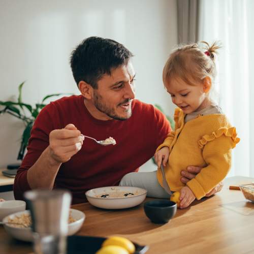 Resident feeding her daugther at The Heights at Happy Valley in Happy Valley, Oregon