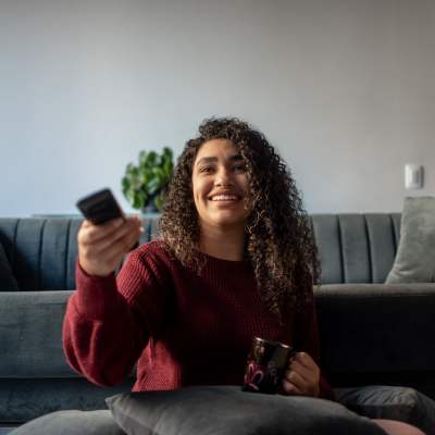 Resident watching television at Campbell Run Apartments in Woodinville, Washington