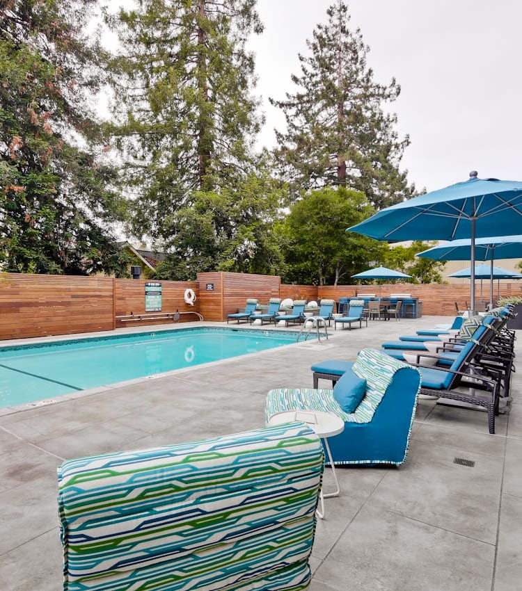Lounge seating and chaise lounge chairs near the pool at Mia in Palo Alto, California