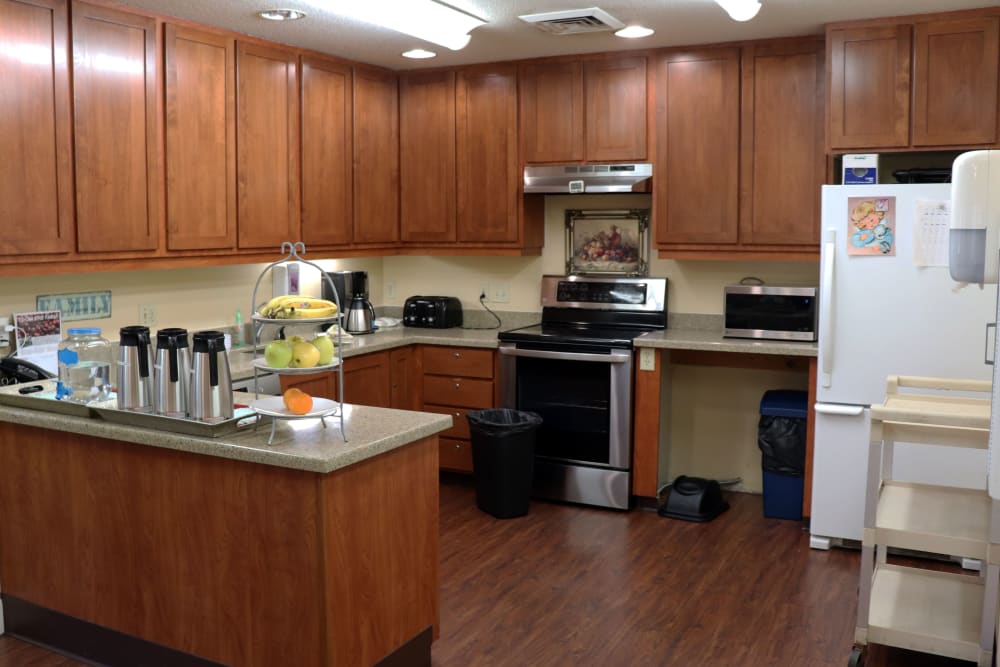 Kitchen inside upscale senior living apartment complete with wood cabinetry at The Springs at Willowcreek in Salem, Oregon