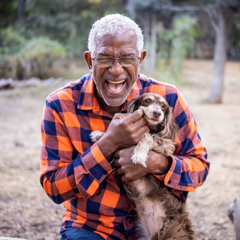 Senior resident holding his dog at Ellsworth Commons Apartments in Greenville, North Carolina
