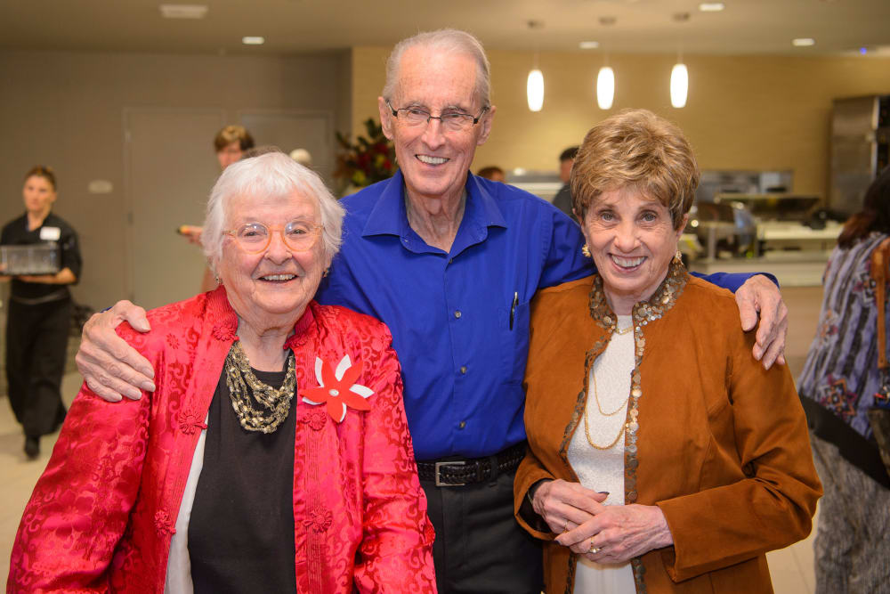 Resident friends enjoying a party at Merrill Gardens at Monterey in Monterey, California. 