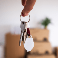 Resident holding up a key to their new place at Clark-Whitehill Enterprises, Inc. in Virginia Beach, Virginia