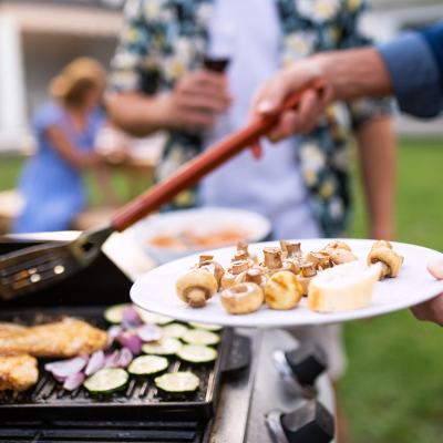 Residents cooking at a BBQ during a community event at The Village at Whitehurst Farm in Norfolk, Virginia