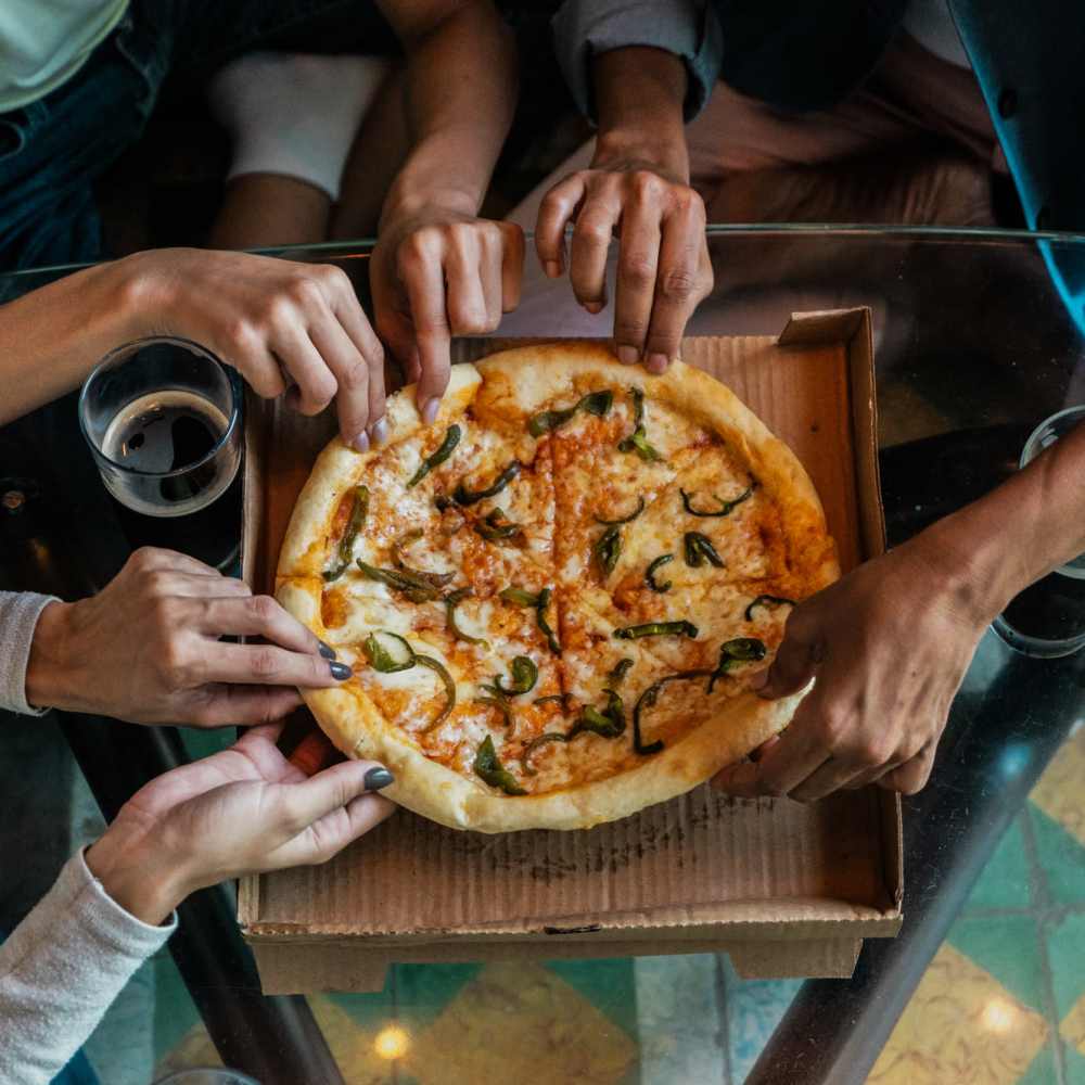Group of residents having pizza near Walnut Trace in Raleigh, North Carolina
