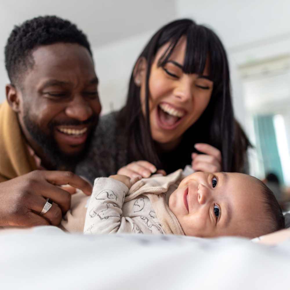 A happy family in their apartment bedroom at Arlington Trace in Greenville, North Carolina