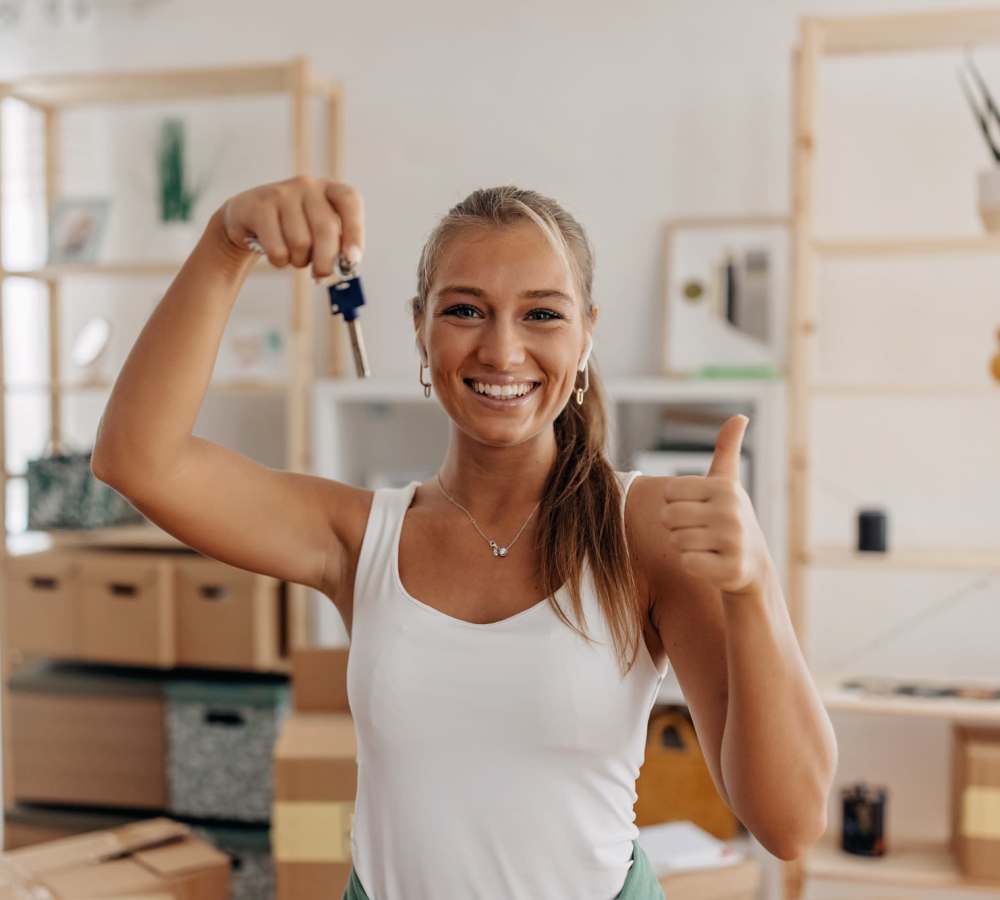 Resident posing with her new keys at 1801L Apartments in Sacramento, California