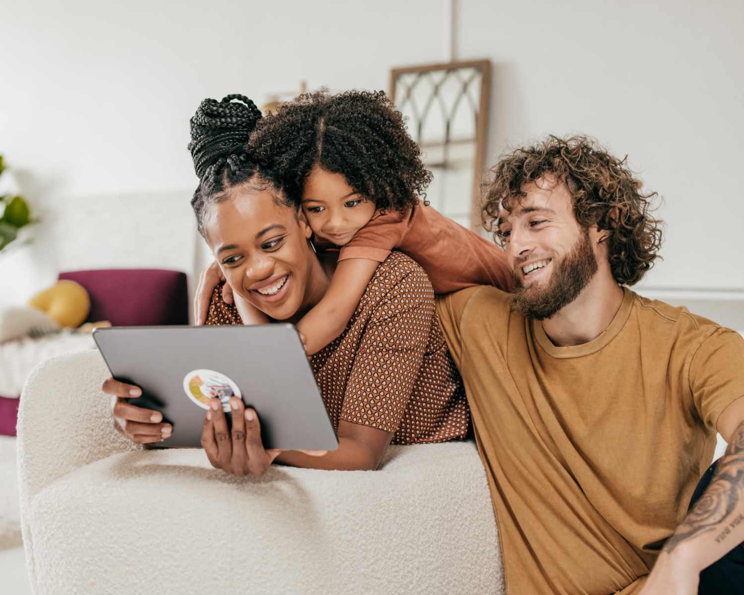Happy family in the apartment loving room at Flats at Stone Hogan in Atlanta, Georgia