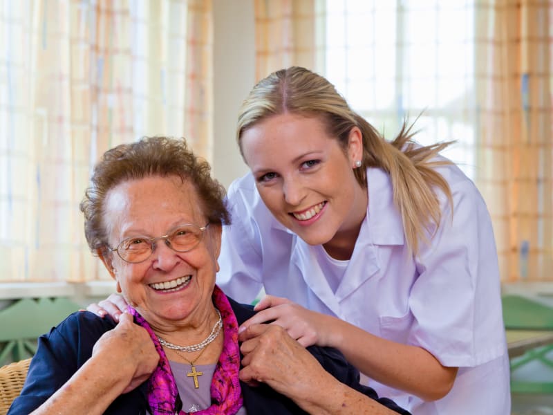 Resident smiling with a caretaker at Maple Ridge Care Center in Spooner, Wisconsin