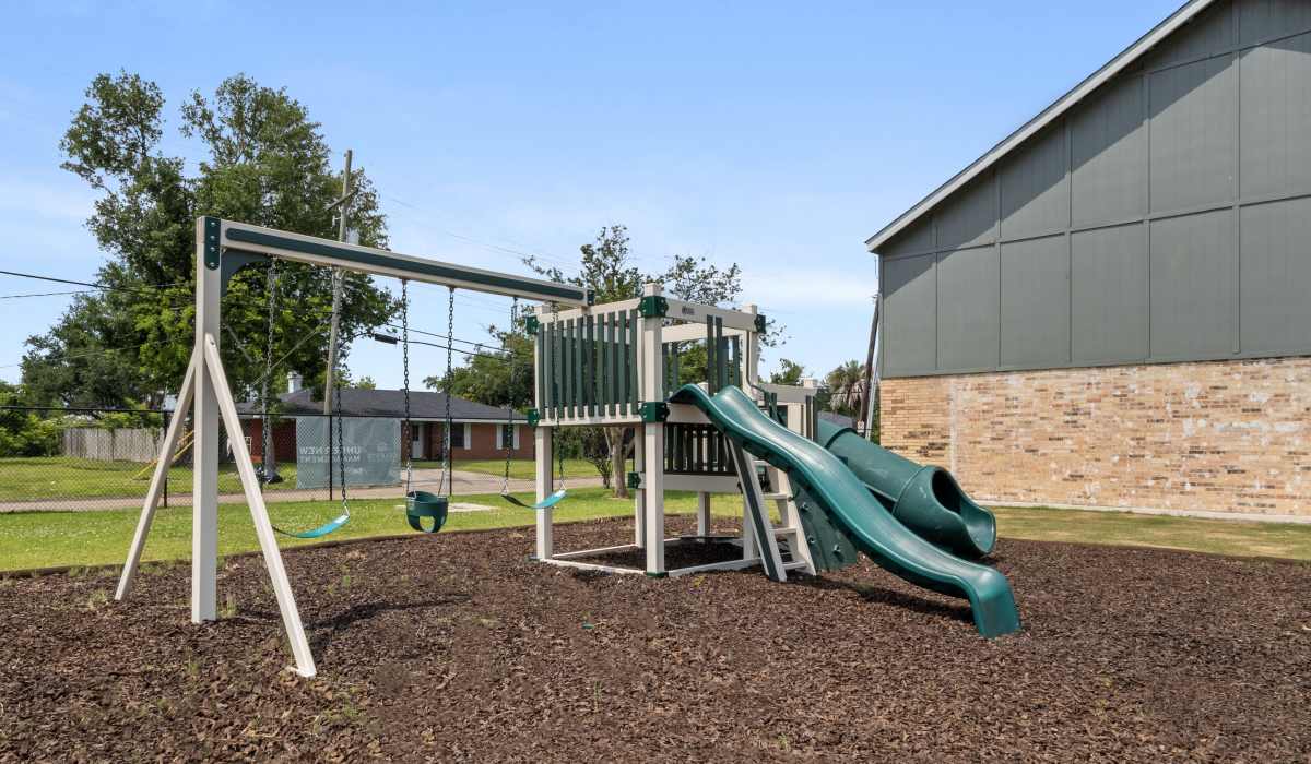 Playground with swing and slide at Celeste in Lake Charles, Louisiana