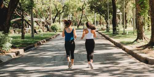 Couple of women jogging at a park nearby Jefferson Cunningham Apartments in Los Angeles, California