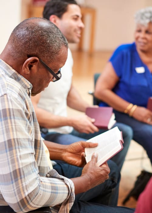 Group of residents reading books together at Burton Health Care Center in Burton, Ohio