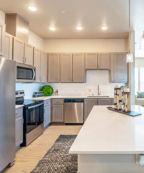 Kitchen with prep island at Alira Apartments in Sacramento, California