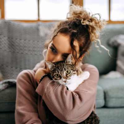 Woman holding a cat in a pet-friendly apartment at Monaco South in Denver, Colorado