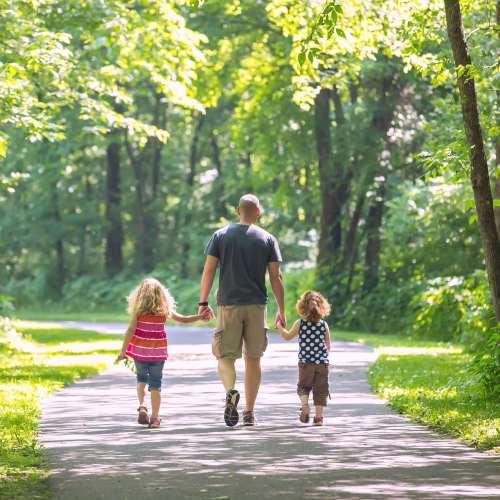 Happy family enjoying walk in the park near {location_name}} in Las Vegas,