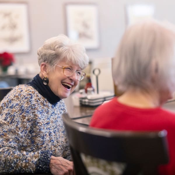 A group of residents outside smiling together at The Township Senior Living in Battlefield, Missouri