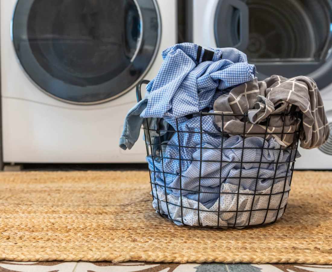 Basket of clothes in front of the washer at Raystone Apartments in Phoenix, Arizona