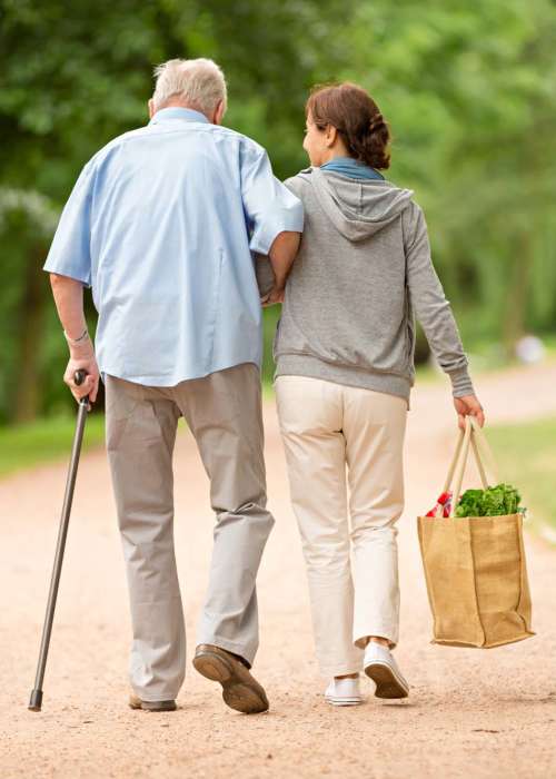 Staff member holding a resident's hands at Tuscan Gardens of Venetia Bay in Venice, Florida