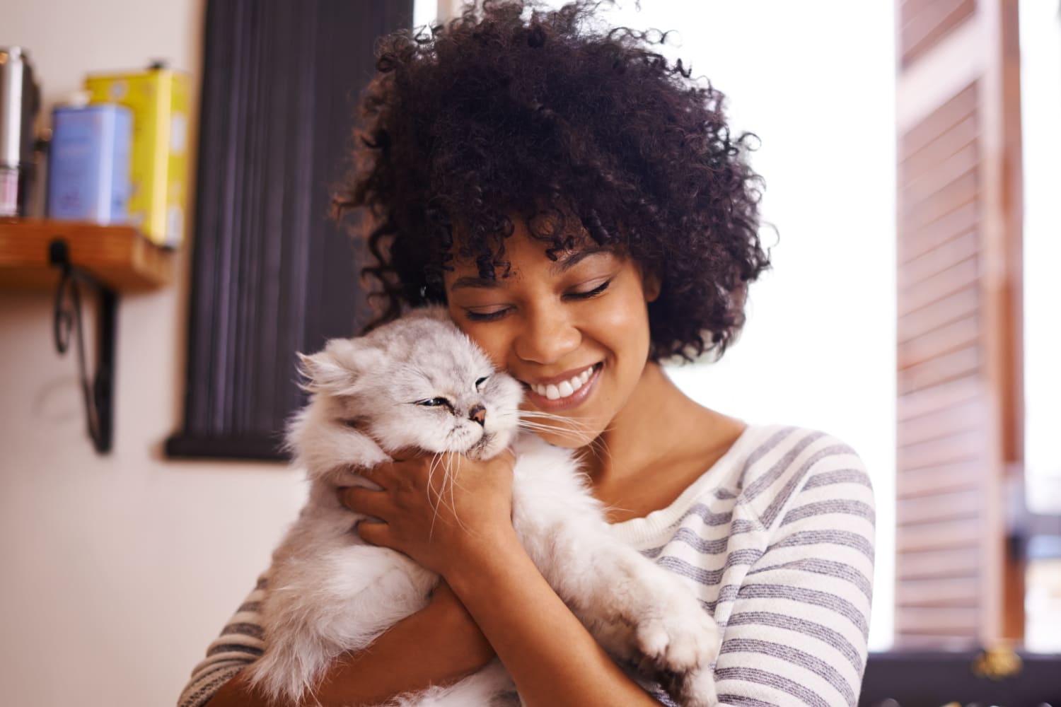 Woman holding her cat up at Gold Mountain Village Apartments in Central City, Colorado