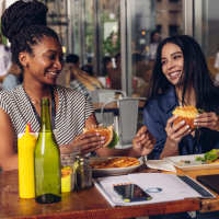 Women enjoying burgers at a restaurant near Cape At Savona Apartments in Cape Coral, Florida