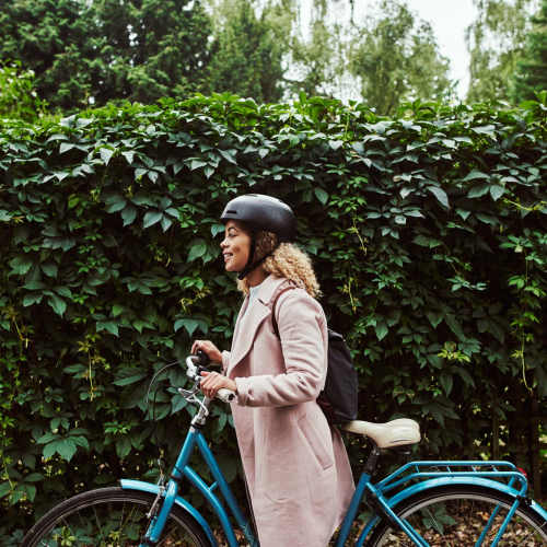 Woman with her bike in downtown at Wasatch Club Apartments in Midvale, Utah