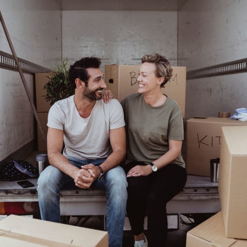 A couple sitting in a moving truck near Red Dot Storage in Kingwood, Texas